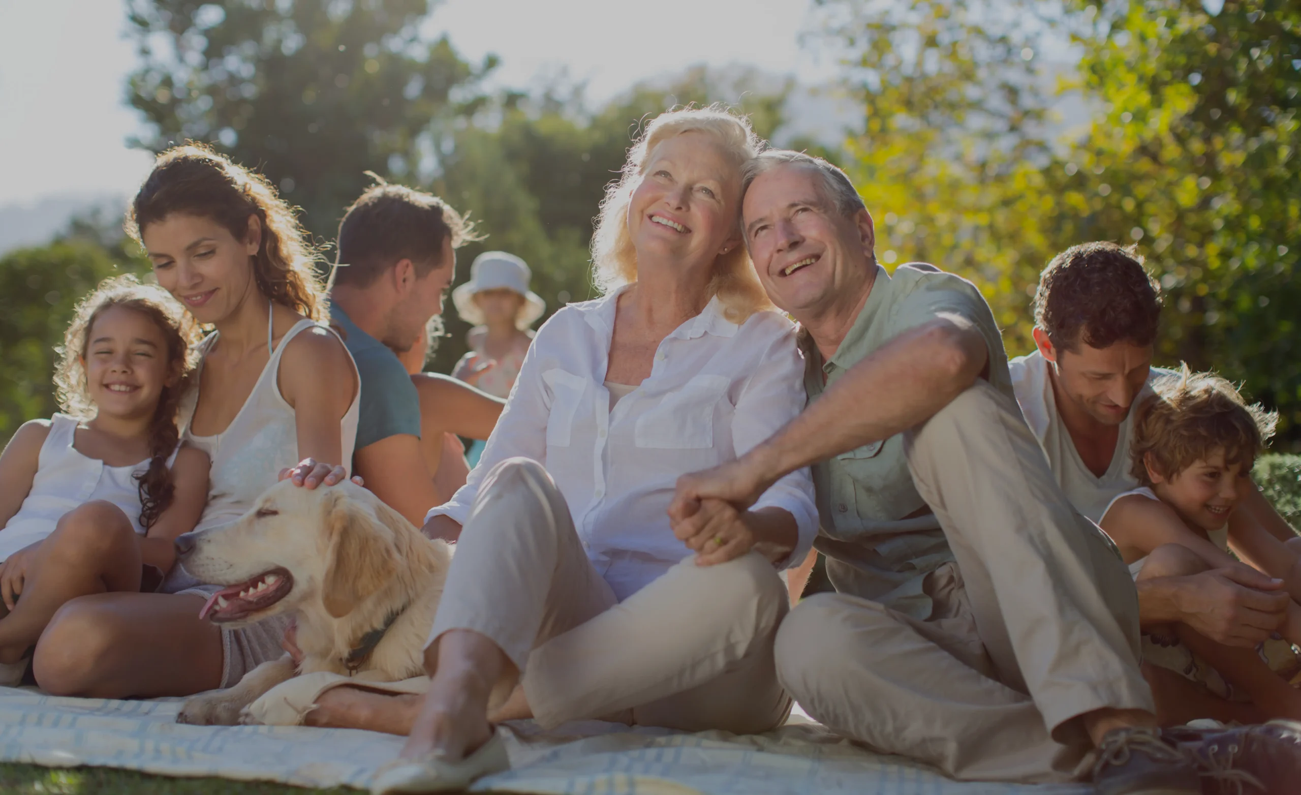Multi-generational family relaxing outdoors together